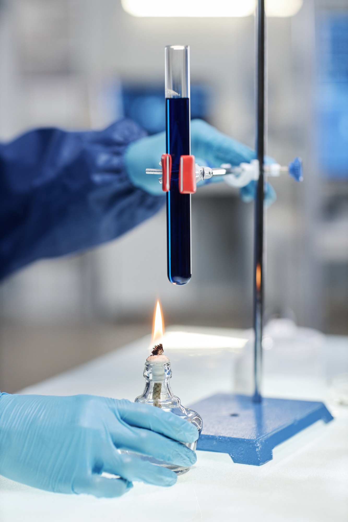 Scientist heating test tube over flame in laboratory