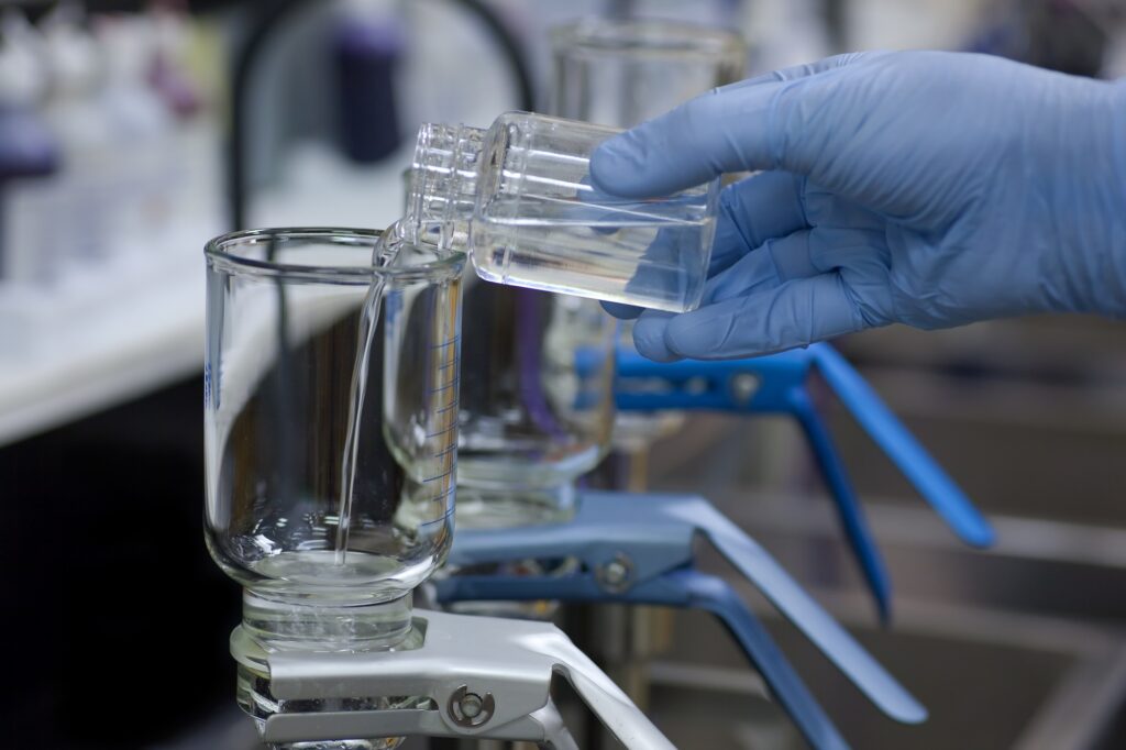 Scientist pouring a water sample into a membrane filter